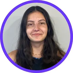 A woman with long hair is smiling for the camera.